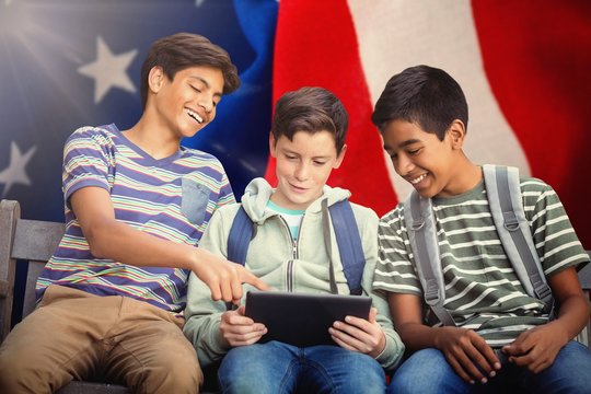 Composite image of boy with friends using digital tablet on