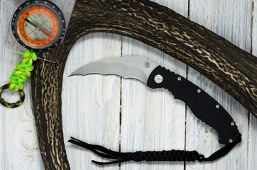 Black knife with black lanyard.