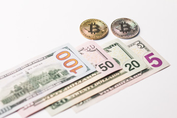 One hundred and seventy five dollars a usa and two coins of crypto currency on a white background.