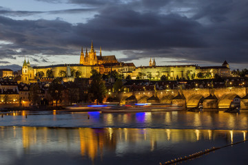 View of Charles Bridge,  Prague Castle and St. Vitus cathedral in twilight with dramatic sky.Prague. Czech Republic .