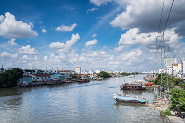 View from a bridge of Ho Chi Minh City to the river with boats. Wooden boats are the transportation on the river