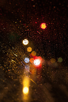 Street Lights Through a Wet Car Window in a Rainy Night in New York