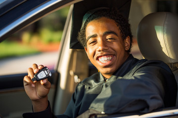 Young man excited about his new car graduation gift.