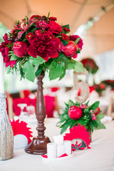 wedding table set for fine dining or another catered event in red colors