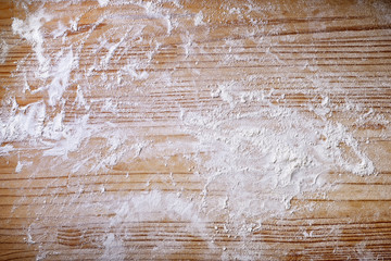 Pastry board with flour. Wooden background, top view, space for text.