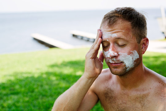 Man Applying A Ridiculous Amount Of Sunscreen