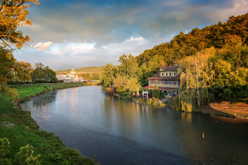 Fototapeta na wymiar Riverbank of spa island in Piestany (Slovakia) in colorful autumn