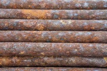rusted discarded industrial pipes
