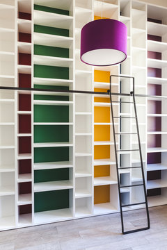 Empty Colorful Bookcase with Metal Ladder