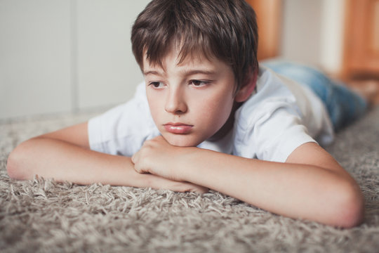 Young boy laying upset on the floor