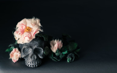 Black skull with flowers and leaves.