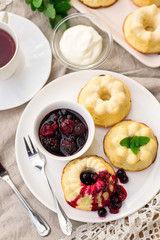 Baked sweet ricotta pudding cheesecake with sour cream and berries