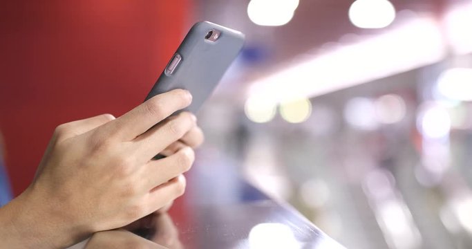 Woman use of mobile phone in station