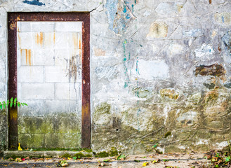 rusted doorframe in a weathered stone wall of an abandoned New England building with copy space