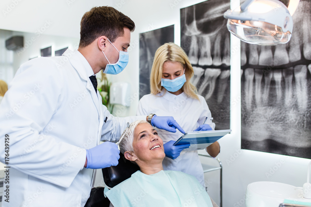 Wall mural Beautiful senior woman receiving a dental treatment.