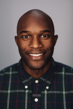 Young African bald man smiling at camera
