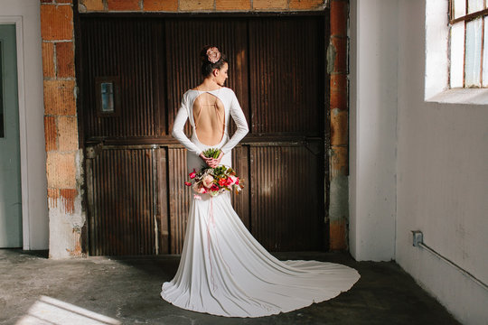 A beautiful woman in a all white dress backless dress