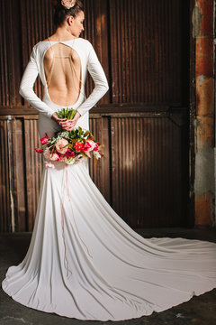 A beautiful woman in a all white dress backless dress