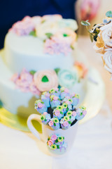 brdie and groom hands near wedding cake