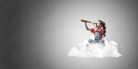 Concept of careless happy childhood with girl dreaming about fut