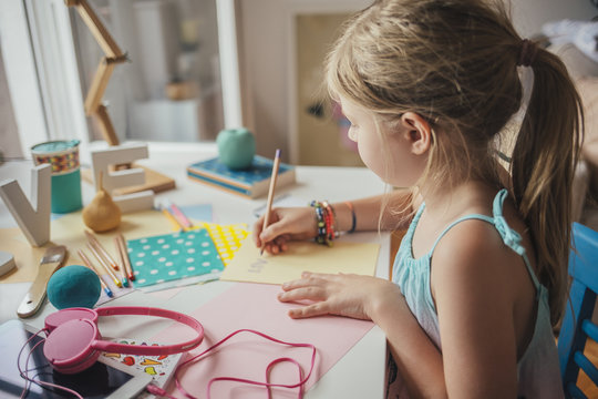 Cute Blonde Girl Writing at Her Desk