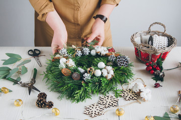 Florist decorator making Christmas wreath