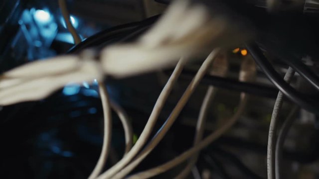 Techical engineer administrator electronic concept: moving down shot of server equipment personal computer localhost mining farm bitcoin, optic cables switches lights ports electronic elements