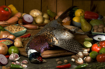 whole pheasant with raw ingredients