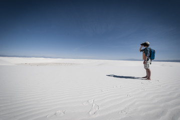 Woman looking binoculars. White Sands National Monument. New Mexico.