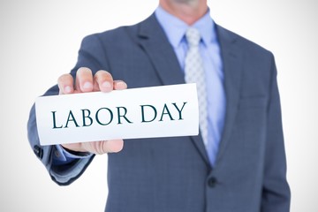 Composite image of midsection of businessman holding blank card