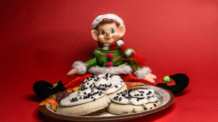 Christmas elf sits down to a plate of Thanksgiving goodies.