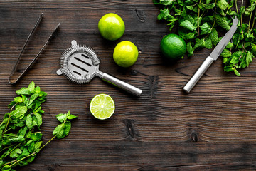 In the bar. Shake mojito. Lime, mint., barman tools on wooden background top view