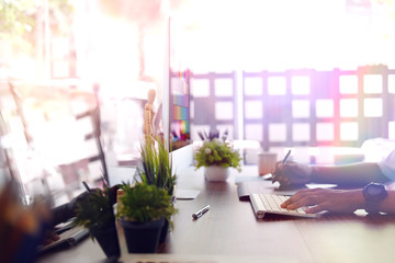Creative businessman drawing on graphic tablet while using modern desktop computer in office. Blank screen for graphic display montage.
