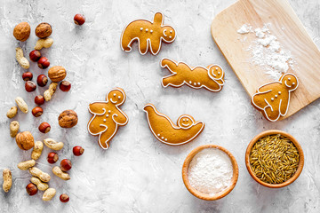 Healthy food for sportsman. Cookies in shape of yoga asanas near nuts on stone background top view