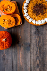 Obraz na płótnie Canvas Pumpkin pie for thanksgiving day on dark wooden background top view copyspace