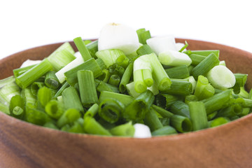 chopped green onions wooden bowl
