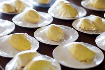 Fresh peel off durian wrapped on plastic dish.