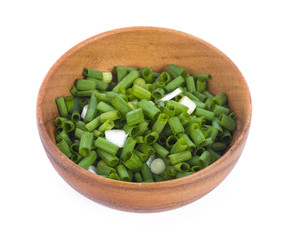 sliced onion leaf in wooden bowl isolated on white