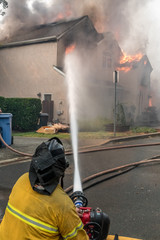 Firefighters defending home on fire. Sonoma County, California, United States, Monday, 9th October,...