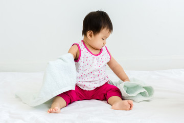 Fototapeta premium Portrait of adorable baby sitting with towel, indoors