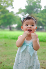 Fototapeta premium Asian Adorable baby girl playing in park. Beautiful smiling cute baby