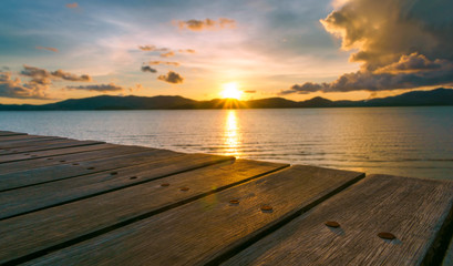 Fototapeta na wymiar Landscape of paradise tropical island beach with empty wood bench, sunrise shot
