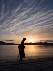 人物　女性　夕日　シルエット　反射　水面