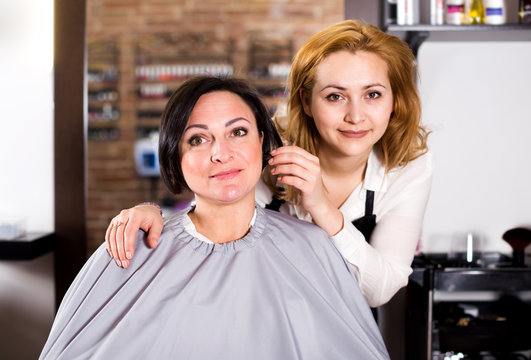 Woman consults with a young hairdresser
