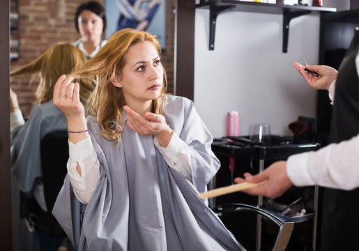 Unhappy woman in hairdress salon