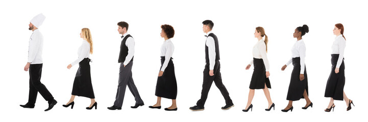 Young Restaurant Staff Walking In Row
