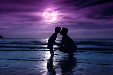 Father's day. Silhouette side view of loving child kissing her father.