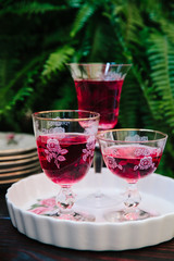 Colorful alcoholic cocktails in beautiful vintage glassware on a wooden table