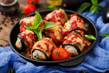 Eggplant (aubergine) rolls with meat in tomato sauce. Flat lay. Top view