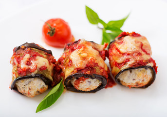 Eggplant (aubergine) rolls with meat in tomato sauce. Flat lay. Top view